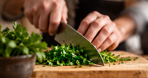 Fresh herbs being chopped on a wooden board