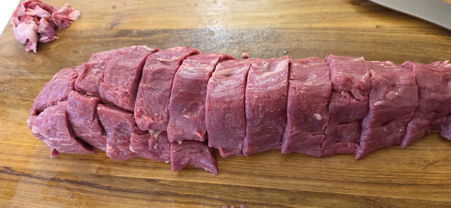 A whole eye fillet cut into portions and slices