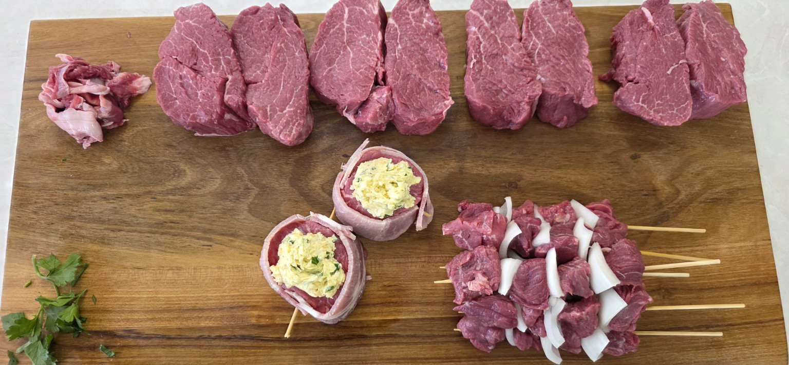 The finished eye fillet breakdown with steaks, beef mignons and kebabs displayed on a full board