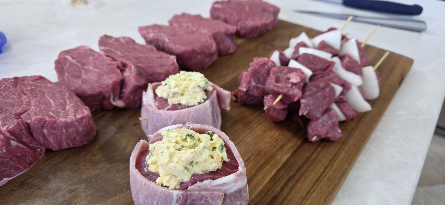 Cube roll steaks, skewers and other portions displayed together at an angle